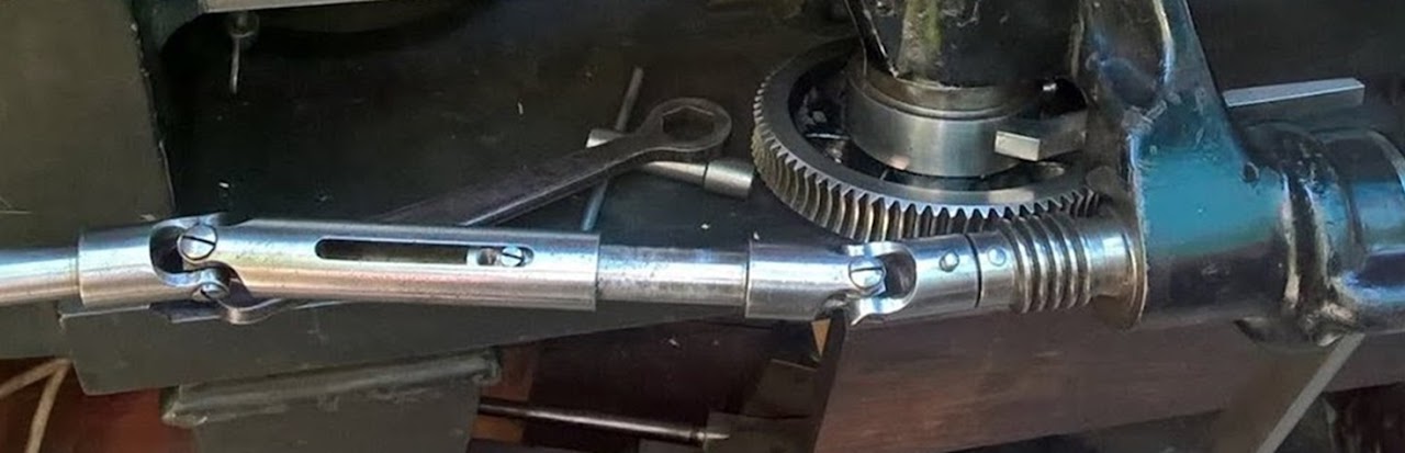 a universal joint 'spider', with one cap off, showing needle bearings